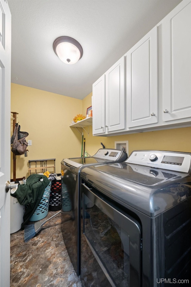 821 Camelot Dr, Negaunee, MI 49866 - washroom with separate washer and dryer, cabinet space, and stone finish flooring
