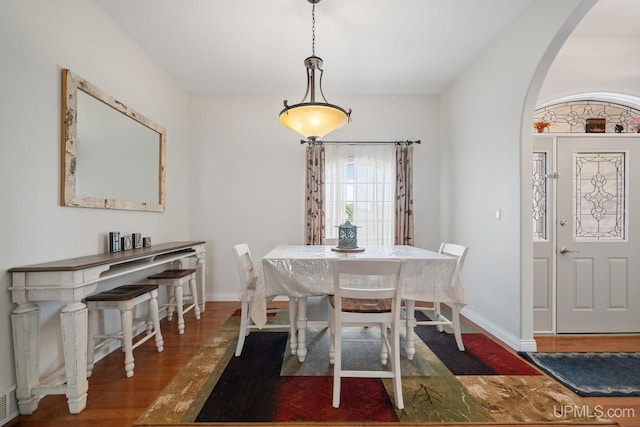 821 Camelot Dr, Negaunee, MI 49866 - dining area with arched walkways and wood finished floors