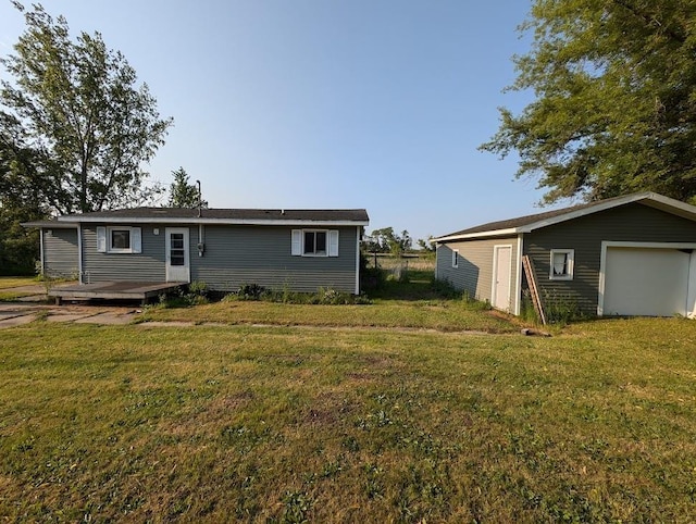 304 Beech St, Kawkawlin, MI 48706 - back of house featuring a lawn, an outdoor structure, and a wooden deck