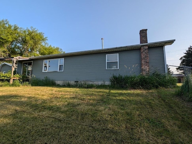 304 Beech St, Kawkawlin, MI 48706 - view of side of home with a chimney and a yard