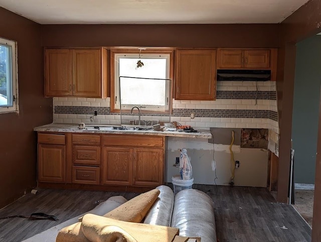 304 Beech St, Kawkawlin, MI 48706 - kitchen with dark wood-style flooring, backsplash, under cabinet range hood, and light countertops