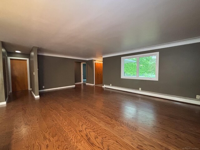 10301 County Farm Rd, Parma, MI 49269 - empty room featuring a baseboard heating unit, wood finished floors, and ornamental molding