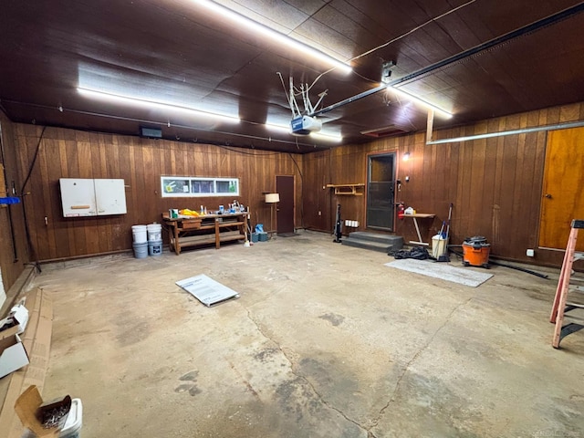 10301 County Farm Rd, Parma, MI 49269 - garage featuring wood walls, a garage door opener, and a workshop area
