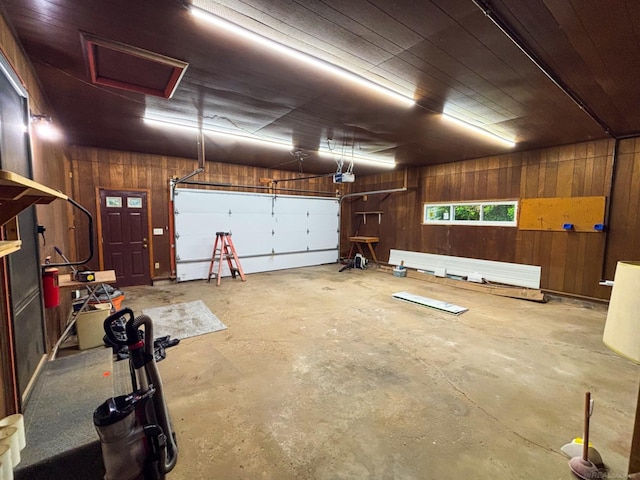 10301 County Farm Rd, Parma, MI 49269 - garage with wood walls and a garage door opener