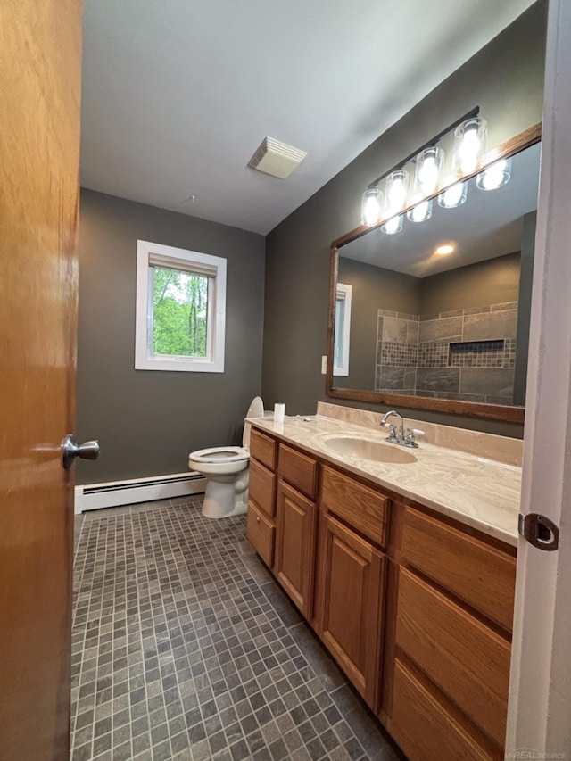 10301 County Farm Rd, Parma, MI 49269 - bathroom featuring a baseboard heating unit, tile patterned flooring, and vanity