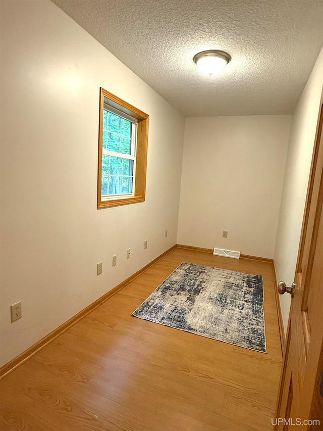 2003 Spruce Ln, Houghton, MI 49931 - empty room featuring wood finished floors and a textured ceiling