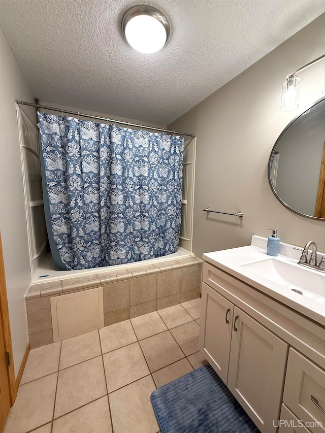 2003 Spruce Ln, Houghton, MI 49931 - bathroom with a textured ceiling, tiled shower / bath combo, vanity, and tile patterned flooring