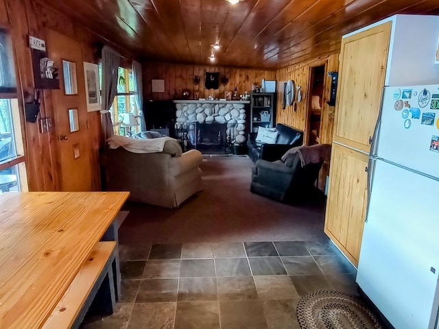 801 W Rd, Harrison, MI 48625 - living area featuring wooden walls, wood ceiling, a fireplace, and dark carpet
