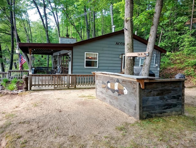 801 W Rd, Harrison, MI 48625 - back of house with a chimney and a wooden deck