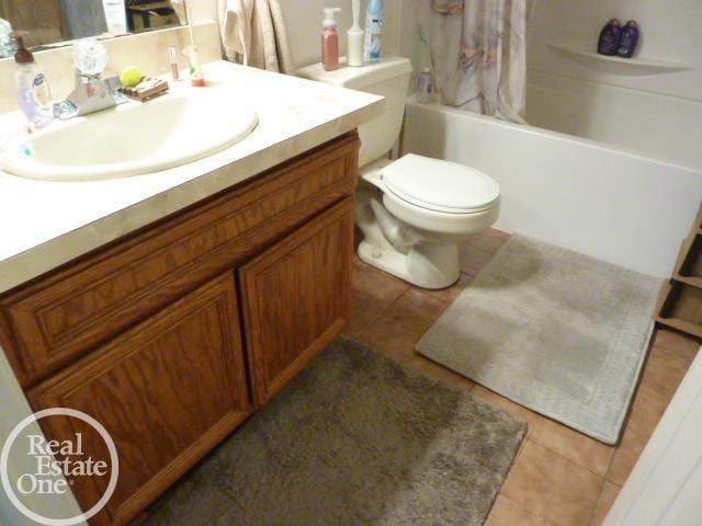 20127 14 Mile Rd, Clinton Township, MI 48035 - full bathroom featuring vanity, tile patterned flooring, and shower / bath combo with shower curtain