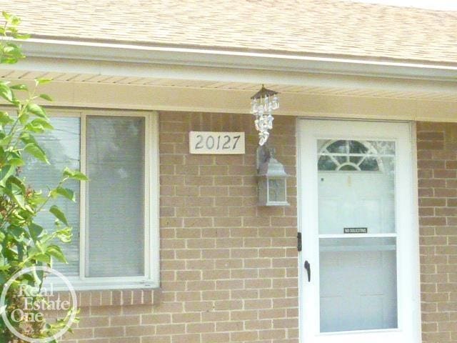 20127 14 Mile Rd, Clinton Township, MI 48035 - property entrance with roof with shingles and brick siding