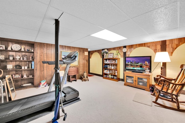 4112 Adams Dr, Shelby Twp, MI 48316 - exercise area featuring wood walls, a paneled ceiling, carpet flooring, built in features, and arched walkways