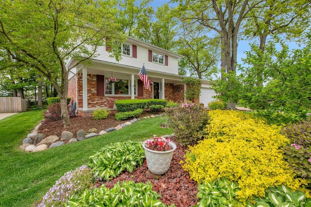 4112 Adams Dr, Shelby Twp, MI 48316 - traditional-style home with brick siding, an attached garage, and a porch