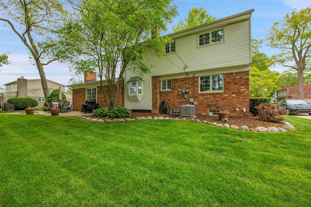 4112 Adams Dr, Shelby Twp, MI 48316 - rear view of house featuring brick siding, a lawn, and a chimney