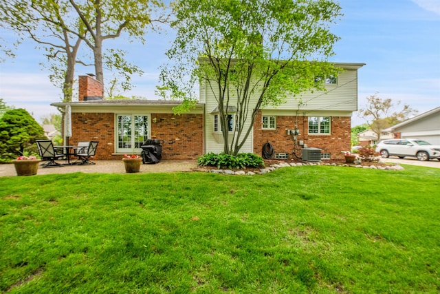 4112 Adams Dr, Shelby Twp, MI 48316 - rear view of house featuring brick siding, a lawn, and a chimney