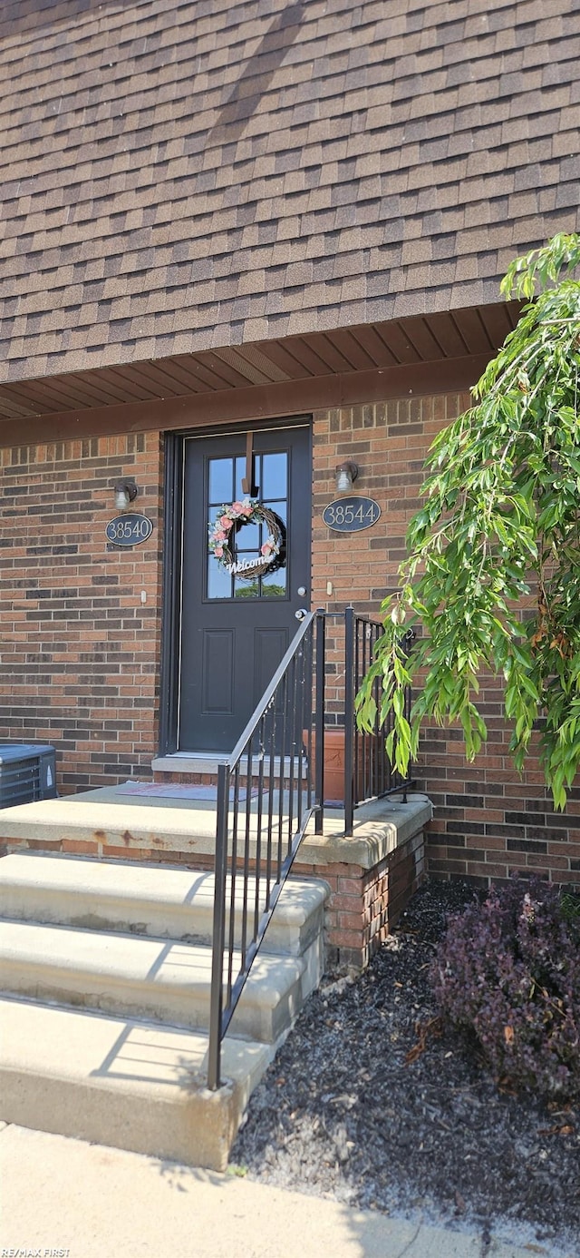 38544 Lanse Creuse St Unit 12, Harrison Twp, MI 48045 - property entrance featuring brick siding and roof with shingles