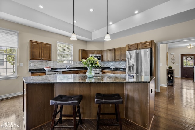 32 River Ln, Grosse Pointe Woods, MI 48236 - kitchen with appliances with stainless steel finishes, backsplash, dark wood-style flooring, plenty of natural light, and recessed lighting