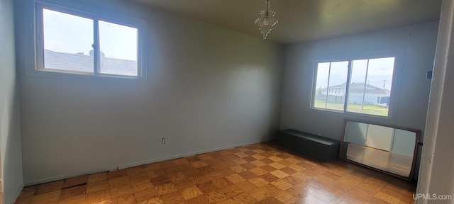 113 Albatross St, Gwinn, MI 49841 - spare room with baseboards and a chandelier