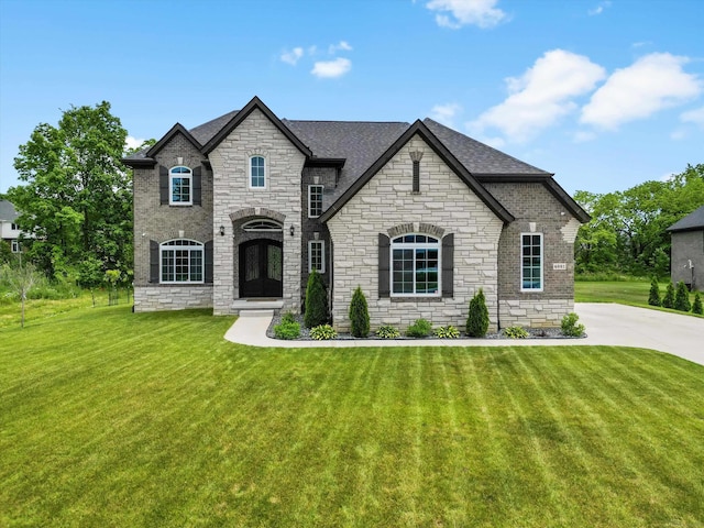 4661 Applewood Ct, Rochester, MI 48306 - french country home featuring stone siding, a front lawn, and a shingled roof
