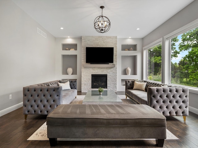 4661 Applewood Ct, Rochester, MI 48306 - living area featuring built in shelves, dark wood-style flooring, a fireplace, and a chandelier