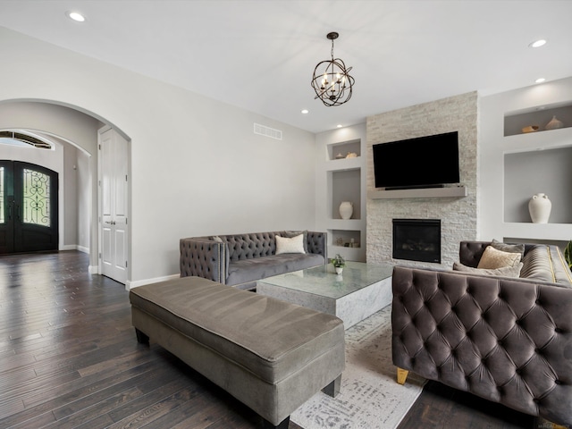 4661 Applewood Ct, Rochester, MI 48306 - living room with built in features, arched walkways, dark wood-style flooring, recessed lighting, and a chandelier