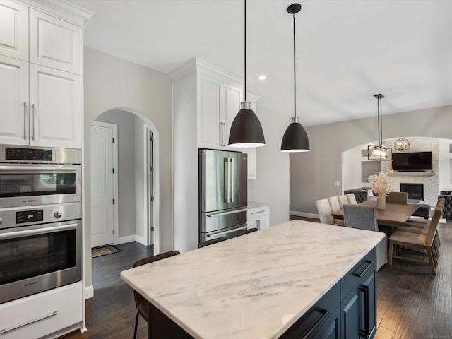 4661 Applewood Ct, Rochester, MI 48306 - kitchen featuring appliances with stainless steel finishes, arched walkways, white cabinets, and recessed lighting