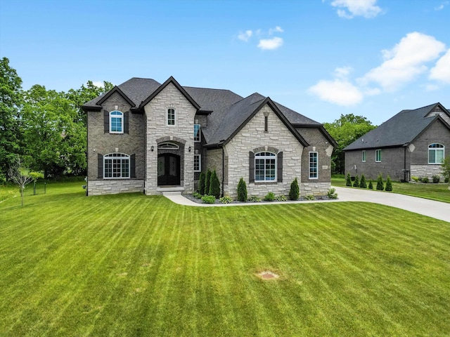 4661 Applewood Ct, Rochester, MI 48306 - french country home featuring stone siding, a front yard, and a shingled roof