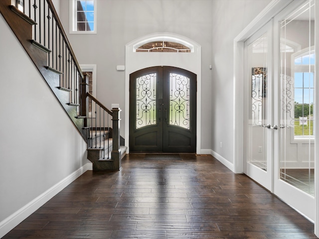 4661 Applewood Ct, Rochester, MI 48306 - entrance foyer with french doors, hardwood / wood-style floors, a towering ceiling, stairs, and arched walkways