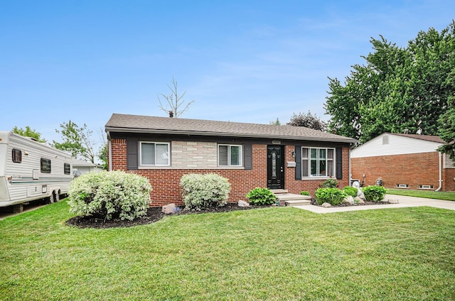 34147 Whittaker St, Clinton Township, MI 48035 - view of front of house featuring brick siding, a front yard, and roof with shingles