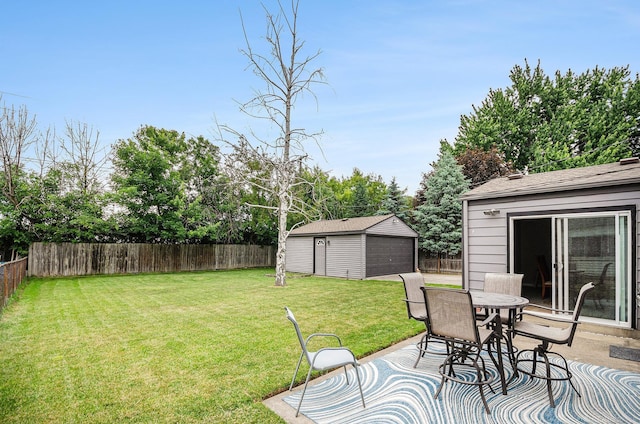 34147 Whittaker St, Clinton Township, MI 48035 - fenced backyard featuring an outbuilding, outdoor dining space, and view of wooded area