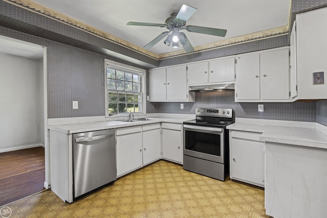 5541 Houghten Dr, Troy, MI 48098 - kitchen featuring appliances with stainless steel finishes, under cabinet range hood, wallpapered walls, light countertops, and white cabinets