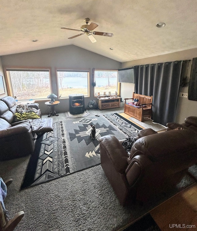 790 N Horseshoe Lake Dr, Gwinn, MI 49841 - carpeted living room featuring vaulted ceiling, ceiling fan, recessed lighting, and a wood stove