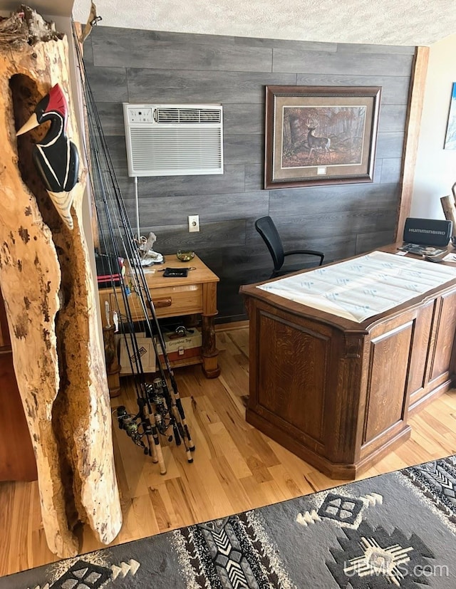 790 N Horseshoe Lake Dr, Gwinn, MI 49841 - home office featuring light wood-style floors, a wall mounted air conditioner, and wood walls