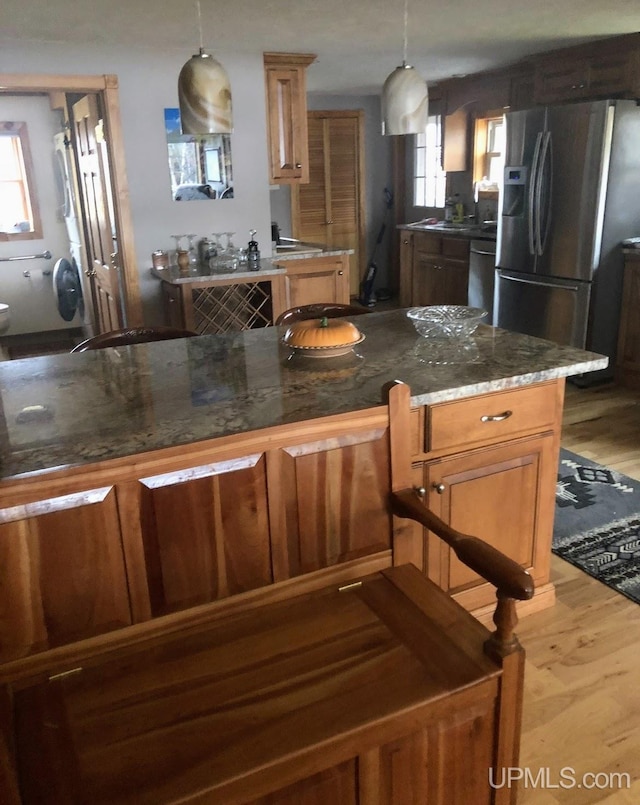 790 N Horseshoe Lake Dr, Gwinn, MI 49841 - kitchen featuring stainless steel refrigerator with ice dispenser, healthy amount of natural light, wood finished floors, and dishwasher