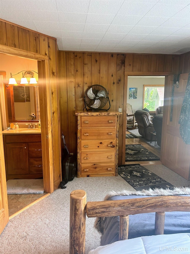 790 N Horseshoe Lake Dr, Gwinn, MI 49841 - bedroom with carpet floors, wood walls, and connected bathroom