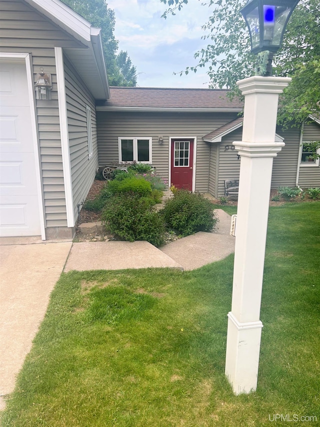 790 N Horseshoe Lake Dr, Gwinn, MI 49841 - doorway to property featuring a yard and a garage