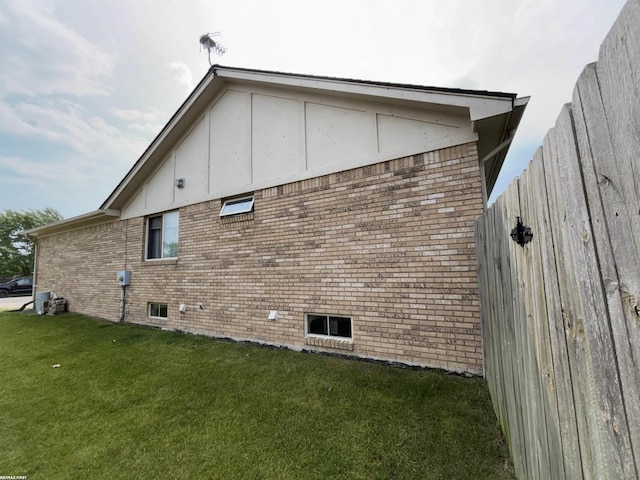 51767 Huntley Ave, New Baltimore, MI 48047 - view of side of home with a yard and brick siding