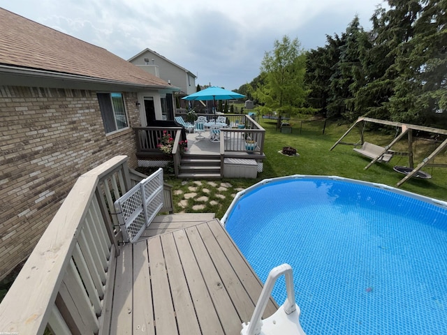 51767 Huntley Ave, New Baltimore, MI 48047 - outdoor pool featuring a wooden deck and a fenced backyard