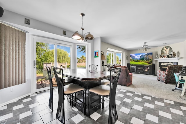52047 Sycamore Dr, Chesterfield, MI 48047 - dining area with a ceiling fan, a fireplace, and a chandelier