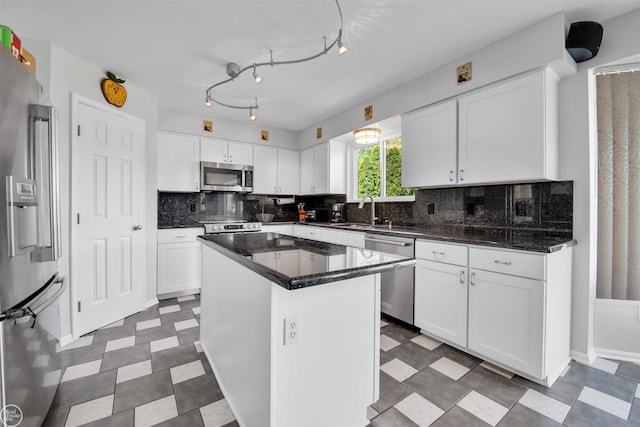 52047 Sycamore Dr, Chesterfield, MI 48047 - kitchen with stainless steel appliances, tile patterned floors, white cabinets, decorative backsplash, and a kitchen island