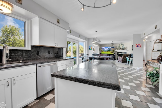 52047 Sycamore Dr, Chesterfield, MI 48047 - kitchen with dishwasher, tasteful backsplash, a center island, open floor plan, and white cabinetry