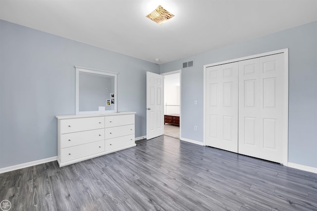 52047 Sycamore Dr, Chesterfield, MI 48047 - unfurnished bedroom featuring wood finished floors and a closet