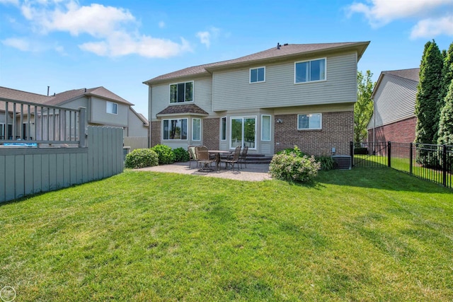 52047 Sycamore Dr, Chesterfield, MI 48047 - back of house with brick siding, a fenced backyard, and a patio
