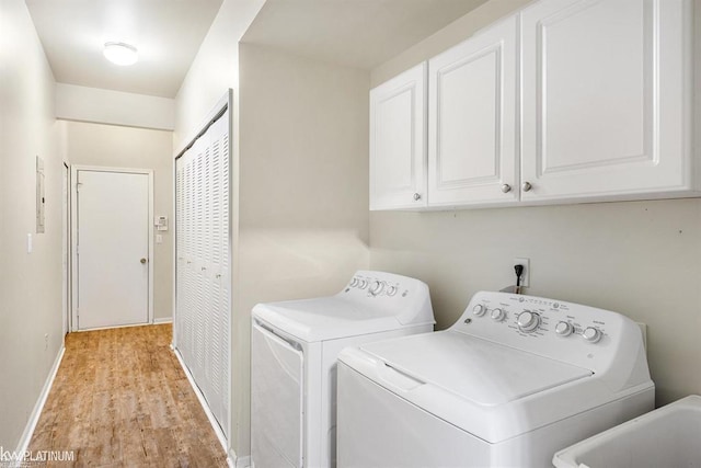 45592 Warwick Dr, Macomb Twp, MI 48044 - laundry room featuring cabinet space, washer and clothes dryer, and light wood-style floors