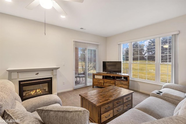 45592 Warwick Dr, Macomb Twp, MI 48044 - carpeted living room with a glass covered fireplace, a ceiling fan, and recessed lighting