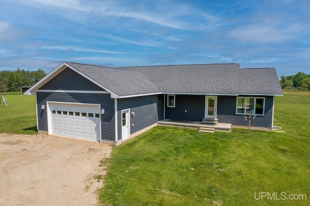 1084 15.5 Rd, Bark River, MI 49807 - view of front facade with driveway, an attached garage, a shingled roof, a front yard, and a porch