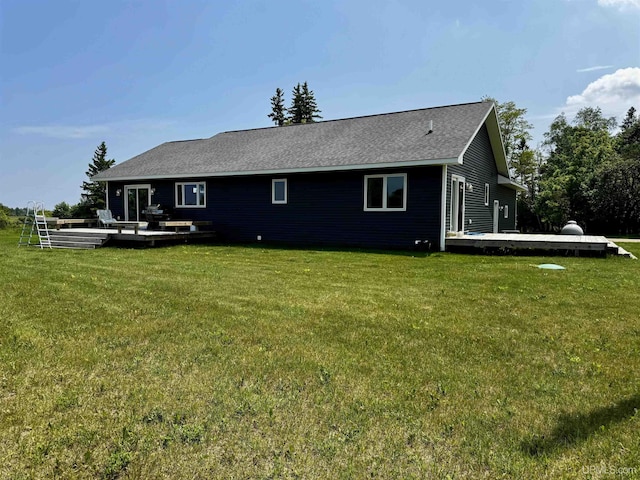 1084 15.5 Rd, Bark River, MI 49807 - rear view of property featuring a lawn and a wooden deck