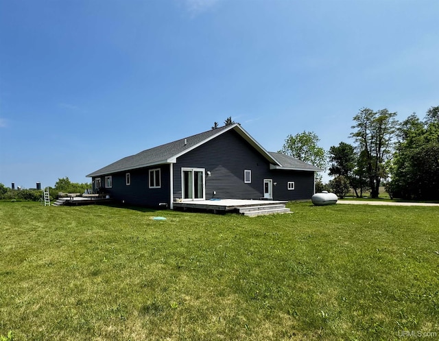 1084 15.5 Rd, Bark River, MI 49807 - view of home's exterior with a wooden deck and a lawn