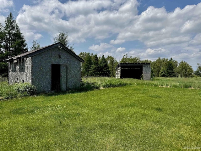 1084 15.5 Rd, Bark River, MI 49807 - view of grassy yard with a storage unit