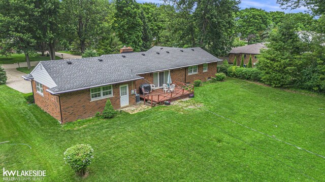 3480 Devonshire St, Sterling Heights, MI 48310 - rear view of house featuring brick siding, a deck, a chimney, and a lawn